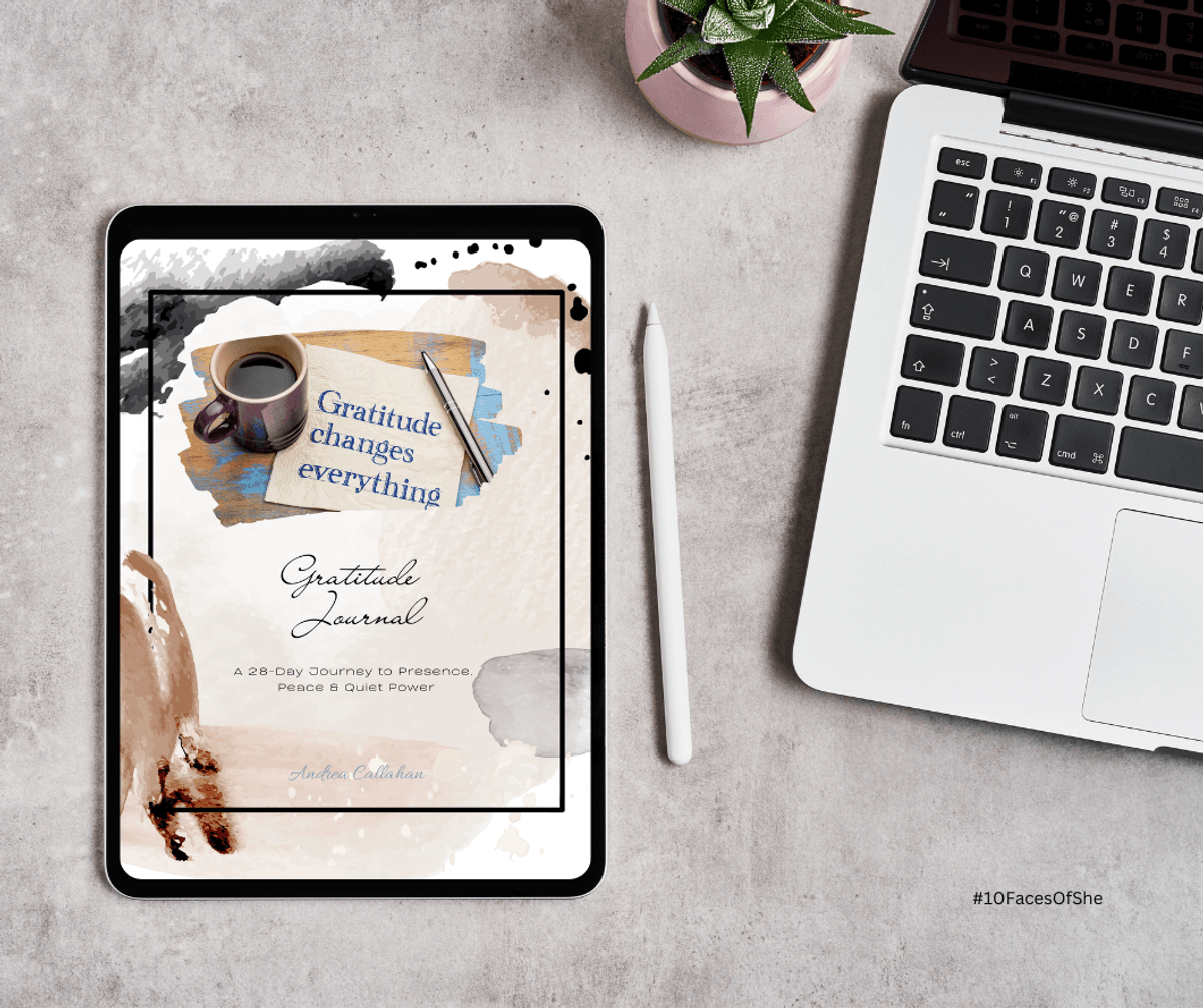 Gratitude Journal by Andrea Callahan on a table next to a laptop