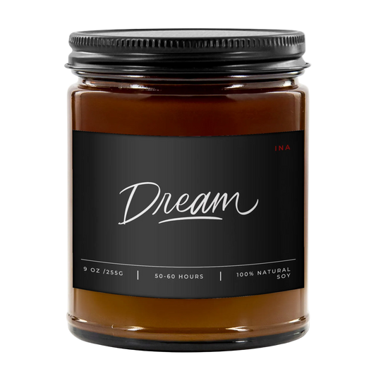 Candle jar labeled 'Dream' with a black lid on a white background