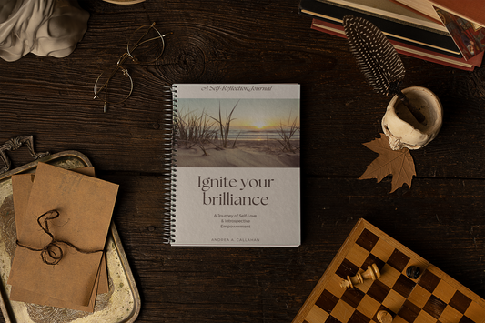 Ignite Your Brilliance Journal by Andrea Callahan on a table with chess board, glasses and journal