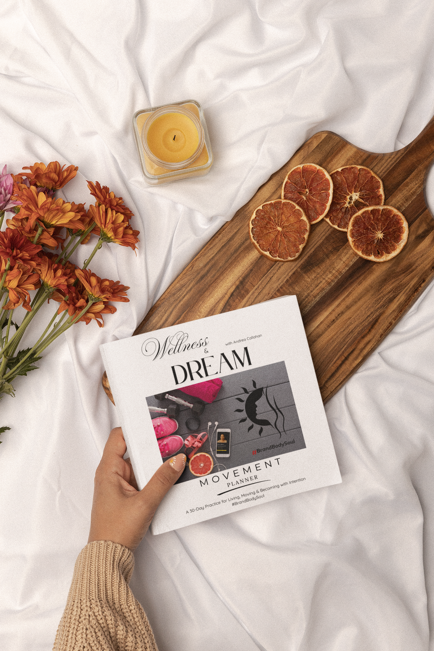 Welness and Dream Movement Fitness Planner with healthy recipes on cutting board